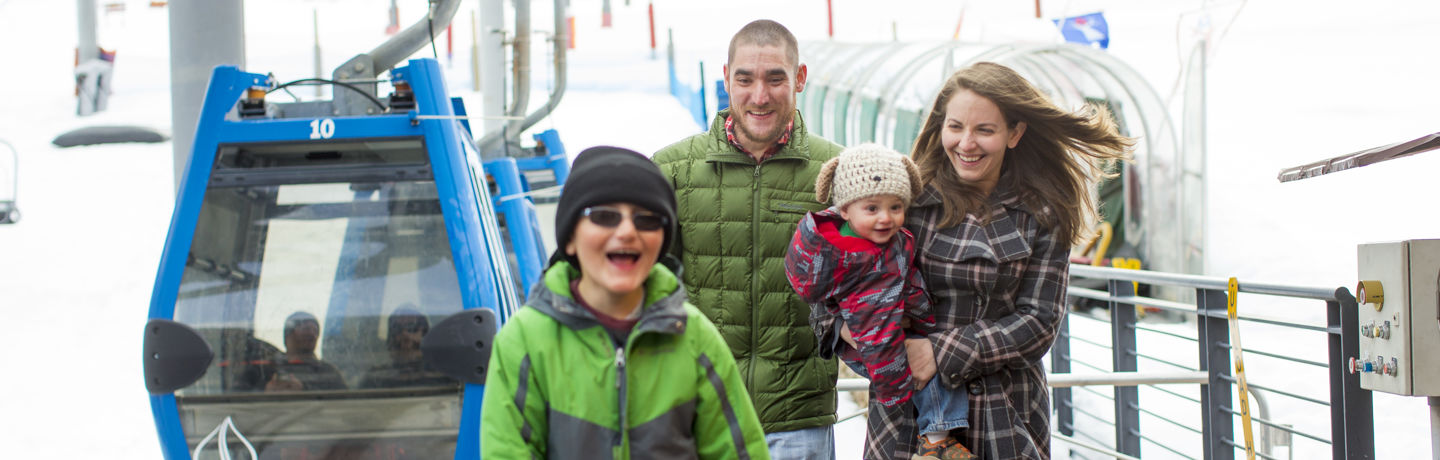 A family enjoys a ride to Base Village in the gondola