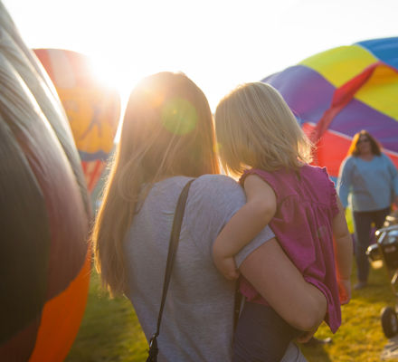 Mother and daughter looking at hot air balloons