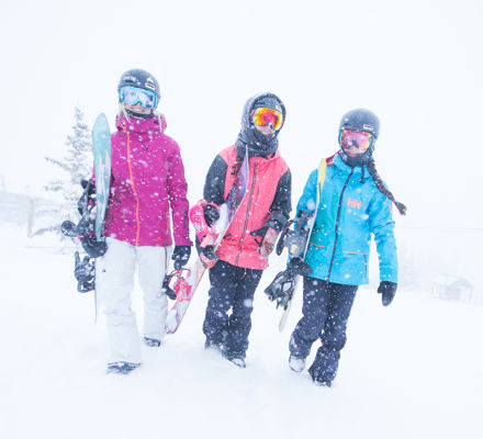 Three snowboarders in Snowmass