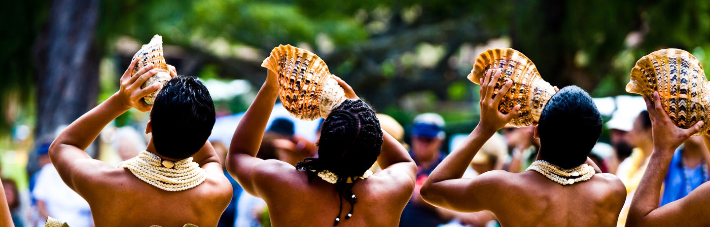 Men Playing Traditional Hawaiian Conch Shell Horns