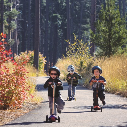 group of kids riding their scooters 