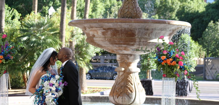 Bride and Groom Behind Fountain