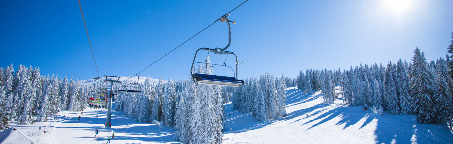 Ski Lift Above Snowy Slopes