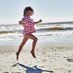 Beach action shot of a little girl 