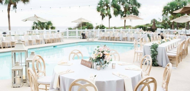 Grand Pavilion Poolside Reception with rented chairs and cafe lighting