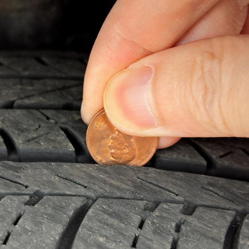 Checking tire tread depth and wear with a penny on Lincoln's head
