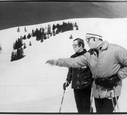 Black and white photo of two men skiing in vail